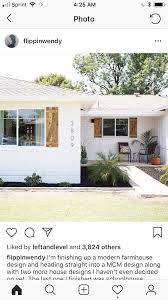 Black And White House With Wood Garage Door White House Black Trim With Natural Wood Shutters Ranch House Exterior White House Black Shutters White Ranch Style House