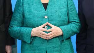 A hand gesture made by resting one's hands in front of the stomach so that the fingertips meet with the thumbs and index. Angela Merkels Trugerische Stabilitat Politik