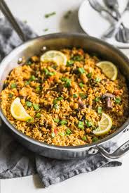 A Quick And Easy Vegetarian Paella Made With Brown Rice Garbanzo Beans Mushrooms Red Peppers And Vegetarian Paella Paella Recipe Easy Healthy Latin Recipes