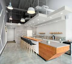 This Modern Coffee Shop Has A Palette Of Grey White And Wood Modern Coffee Shop Coffee Shop Interior Design Coffee Shops Interior