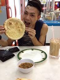 Similar to rota prata in singapore, the roti canai makes for a common breakfast food. Young Man Eating Roti Canai Kuala Lumpur Malaysia Stock Photo Picture And Royalty Free Image Image 22034599