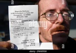 Brian Shutt, a medical marijuana patient, displays his receipt showing the  free gram of marijuana he received from the Magnolia Wellness medical  marijuana dispensary