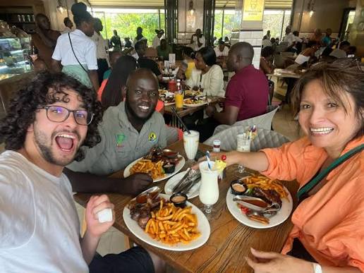 ugandan guide having dinner with his clients 