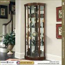 Howard Miller Modern Curve Door Cherry Corner Display Cabinet 680529 Marlowe This Corner Curio Cabinet Is In Corner Display Cabinet Corner Curio Curio Cabinet