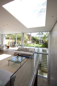 The basement was added to the home's original plan, and in it we were able to slip a large media room, guest room, wine cellar, and laundry. Double Height Lightwells And Sliding Glass Doors