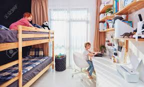 It could be tempting to succumb to the requests of your young one, but remember that his tastes are still evolving. Two Boys Brothers In Kids Room With Bunk Bed And Wall Shelves Stock Photo Picture And Royalty Free Image Image 136666123