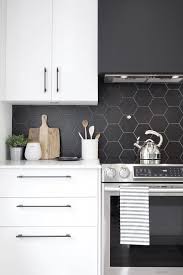 A Minimalist White Kitchen With A Matte Black Hexagon Tile Backsplash Which Is Accented With White G In 2020 Kitchen Remodel Kitchen Backsplash Designs Kitchen Design