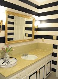 A white and black bathroom is a great choice. Idea For Working With Our Existing Tile Striped Walls Gold Bathroom Decor Funky Bathroom