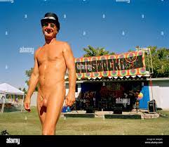 A naked man in a top hat at a music festival Stock Photo - Alamy