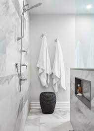 Polished Nickel Towel Hooks Are Mounted Above A Woven Black Stool On A Wall Adjacent To An Open Shower Fitted With An E Open Showers Niche Shelves Shower Stool