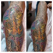Only the eyes of the tiger and the bridge of its nose are depicted in this tiger tattoo. In Progress Tattoo Of A Dragon Fighting A Tiger Tattooing Done By Steve Mcclintock At Illinois Tattoo Company Dragon Fight Illinois Wedding Venues Tattoos