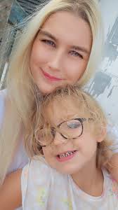 Can somebody remove the strand of hair from my daughter's face.