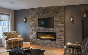After all, a fireplace is the focal point of the room. Dark Gray Wall Paint Color Pleasant Stone Tile Electric Fireplace Striped Fabric Armchair Choco Accent Walls In Living Room Home Fireplace Stone Walls Interior