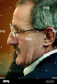 Newton, Kan. resident Greg Moore, accused of killing Harvey County Sheriff  Deputy Kurt Ford, 38, and wounding Hesston, Kan. Detective Sargent Chris  Eilert in April, 2005, listens to testimony during a reliminary