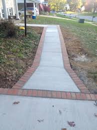 Adding a neat row of belgian block stones to each side the edges of an asphalt driveway need to be cut straight so that the blocks line up evenly against it. Brick Stone Wright S Concrete Of Northen Virginia Concrete Brick Stone Driveways Patios Porches Wall Steps