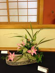 Flax Leaves Rice Flowers Lily And Camellia Leaves In A Semi Double Arrangement Bunga