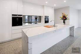 White Gloss Cabinets Marble Island Bench Smoked Mirror Splashback And Polished Concrete Flooring All Ad White Gloss Kitchen Kitchen Marble Concrete Kitchen