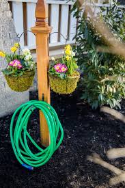 Garden hose storage pots come in a variety of materials, shapes, and colors. Diy Garden Hose Storage With Plant Hangers Hgtv