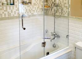 In this configuration, the glass panels are attached to a metal track. Design Your Bathroom With Glass Bathtub Doors Manalapan Nj Showerman Com