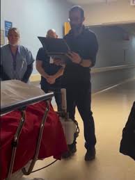 This is Alex Pretti. An ICU nurse, who worked at the Department of Veteran  Affairs hospital in Minneapolis. In this image, Alex was reading to a  Veteran who died of a severe