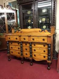 Crafted from solid rubberwood with an antiqued gray finish, this piece features two drawers and two cabinets perfect for tucking away clutter. Antique Buffets How To Use These Sideboards