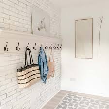 Also, this wall is enriched with a few decorative items, a floating shelf, and a tv. Modern Farmhouse Mudroom Ideas Hallstrom Home