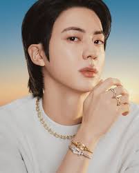 BTS's #Jin, Global Brand Ambassador for Fred, takes the spotlight in the  house's latest campaign, Catch the Sun. Captured in the golden light of  summer, he radiates confidence and brilliance while wearing