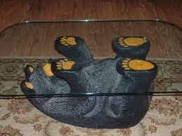 It has an oval glass top, the base is made from stone. Another Bear Coffee Table But This One Has The Oval Glass Switched Out To A Rectangle Shape They Have Also Painted In Black Bear Decor Bear Decor Black Bear