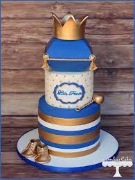 Prince Themed Baby Shower Cake In Royal Blue And Gold With Crown Baby Shoes And Rattle Www Prince Baby Shower Cake Baby Shower Cakes Blue Baby Shower Cake