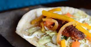 Begin by making the slaw, which is a combination of shredded red cabbage, chopped red onions, cilantro, apple cider. Fish Tacos Paladar Latin Kitchen Rum Bar