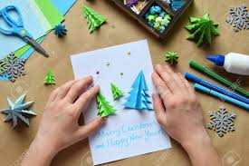 Making your cards for your friends and family can be an enjoyable hobby. Making Greeting Card With Origami 3d Xmas Tree From Paper Merry Christmas And Happy New Year Decoration Children S Diy Concept Handmade Crafts On Holiday With Your Own Hands Stock Photo Picture And