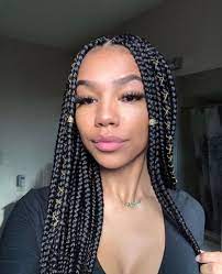While there's a small section of hair up front that is loose to tuck behind ears, most of the top half of the short box braids is pulled back into a cute messy ponytail. Dark Brown Knotless Box Braids Novocom Top