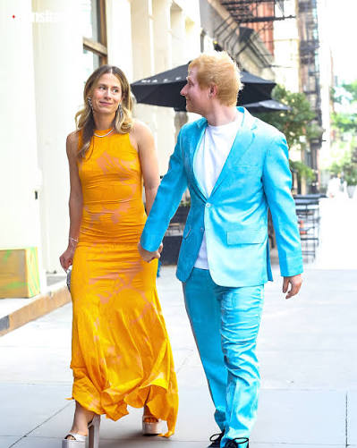 ✨ Ed Sheeran turns heads at Taylor Swift and Travis Kelce's wedding! 💒🎶  The singer arrived with wife Cherry, with the couple grabbing attention in  their vibrant outfits at the star-studded celebration.