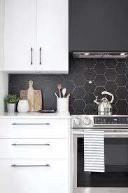 Circular vanity mirror, white countertops and gold pendant lights. 25 Edgy And Catchy Black Kitchen Backsplashes Digsdigs