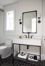 Modern Black And White Bathroom Is Lit By Modern Taper Sconces With Linen Shades Mounted On Either Side White Bathroom White Bathroom Designs Bathroom Interior