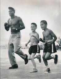 Floyd Patterson Trains For His Upcoming Bout With Hurricane Jackson By Jogging With Ray Pollero Center And Robe Floyd Patterson Boxing Images Boxing History