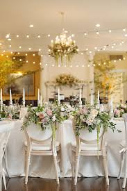 Whitewashed Round Back Upholstered Chairs For The Bride And Groom Adorned With Organic Floral Arrangements A Bride Groom Chairs Sweetheart Chair Preppy Wedding