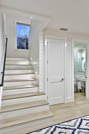 A blonde finish on the railing feels fresh against white trim, while a midcentury modern sideboard tucked below the stairs adds storage. Modern Farmhouse Farmhouse Staircase Austin By Redbud Custom Homes Houzz