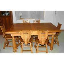 Buying a dining table is an exercise if finding balance between form and function. A Brandt Ranch Oak Draw Leaf Table And 6 Chairs 889395