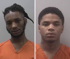 Luther Monroe Harris (right), 20, turned himself in Monday. He's charged  with attempted murder in connection with an Aug. 2 shooting