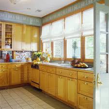 Stain colors for cabinets in san diego, los angeles & orange county. Overall Contemporary Wood Stained Cabinets Brass Pulls Light Green Walls With Geometric White Stenciled Arts And Crafts Pattern As Border Bank Of Windows With Roman Shades Multi Colored Backsplash Stock Photo