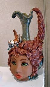 The jug it poured and I sculpted the head right onto jug while it was still  semi wet. Mayco Glaze