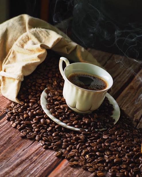 Cup of Black Coffee on Top of Coffee Beans and Saucer · Free Stock Photo
