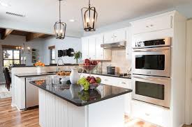 A small kitchen island with a sink, a long dining table and a large modern stove hood. Amazing Before And After Kitchen Remodels Small Kitchen Makeovers Kitchen Remodel Small Kitchen Remodel