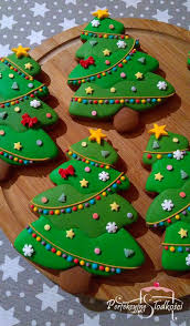 Cropped view of woman holding baked christmas tree cookie in hands with merry christmas illustration. At Hikendip You Can Find The Latest Travel Blogs Food Blogs Fashion And Home Deco Christmas Cookies Decorated Christmas Sugar Cookies Sugar Cookies Decorated
