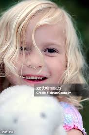 Girl Hugging With Stuffed Dog Toy High-Res Stock Photo
