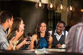 A Group Of Friends Laugh Over Drinks At The Bar Of Vivo Italian Kitchen A Universal Citywalk Resta Universal Orlando Friends Laughing Universal Orlando Resort