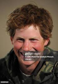 Prince Harry stands with soldiers in his battle group as they pose... News  Photo