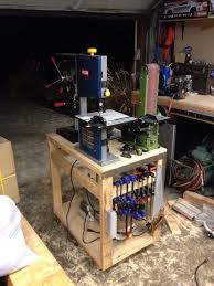 I Made A Tinker Table Out Of Scrap Wood Today It Has My Bench Top Drill Press Belt Disk Sander And Bandsaw It Woodworking Garage Garage Workshop Woodworking