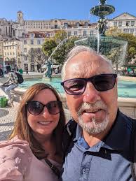 What surf town north of Lisbon has thermal hot springs and a fast train  connection?